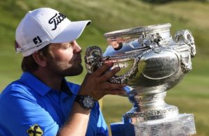 Austria's Bernd Wiesberger holds up his trophy after winning the 2015 Alstom Open de France on July 5, 2015 at Le Golf National in Guyancourt, near Paris. AFP PHOTO / DOMINIQUE FAGET