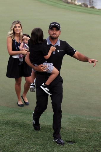 ORLANDO, FL - MARCH 20: Jason Day of Australia walks off the 18th green with his wife Ellie and children Dash and Lucy following the final round of the Arnold Palmer Invitational Presented by MasterCard at Bay Hill Club and Lodge on March 20, 2016 in Orlando, Florida. Sam Greenwood/Getty Images/AFP