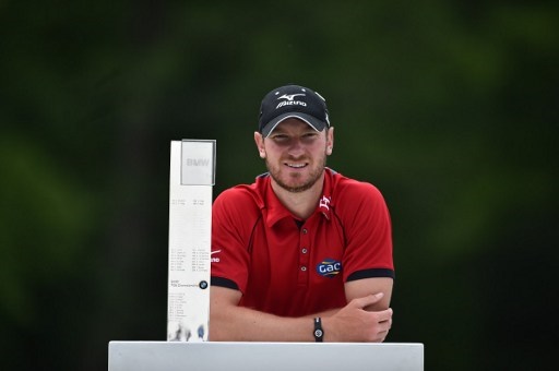 England's Chris Wood poses with the trophy after winning the golf PGA Championship at Wentworth Golf Club in Surrey, south west of London, on May 29, 2016. / AFP PHOTO / BEN STANSALL