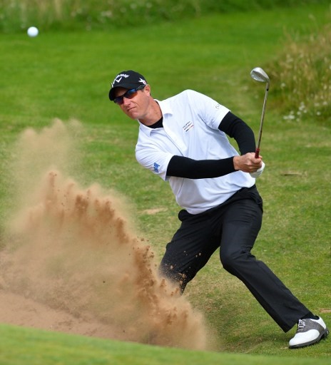 Belgium's Nicolas Colsaerts plays from a green-side bunker on the 8th hole during practice on July 12, 2016, ahead of the 2016 British Open Golf Championship at Royal Troon in Scotland. The 2016 British Open begins on July 14, 2016. / AFP PHOTO / GLYN KIRK / RESTRICTED TO EDITORIAL USE