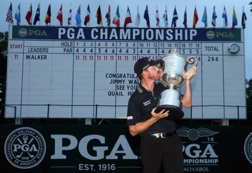 SPRINGFIELD, NJ - JULY 31: Jimmy Walker of the United States celebrates with the Wanamaker Trophy in front of the leaderboard after winning the 2016 PGA Championship at Baltusrol Golf Club on July 31, 2016 in Springfield, New Jersey. Streeter Lecka/Getty Images/AFP