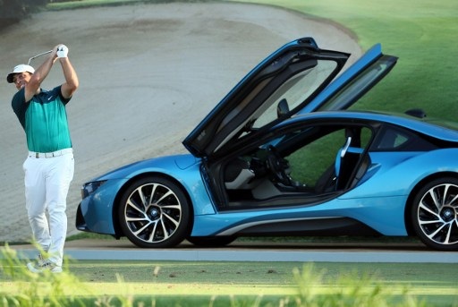 Francesco Molinari of Italy plays a shot, near a BMW i8 hybrid sports car, during day two of the DP World Tour Championship at Jumeirah Golf Estates on November 18, 2016 in Dubai. The year-long Race to Dubai on the European Tour enters its home stretch with the season-ending DP World Tour Championship, with four players still in the hunt to secure the honour of being called Europes No1. With 1,217,175 points for the winner, only No2 Danny Willett, No3 Alex Noren and No4 Rory McIlroy have the chance to catch up with Race to Dubai leader Stenson. / AFP PHOTO / Karim Sahib